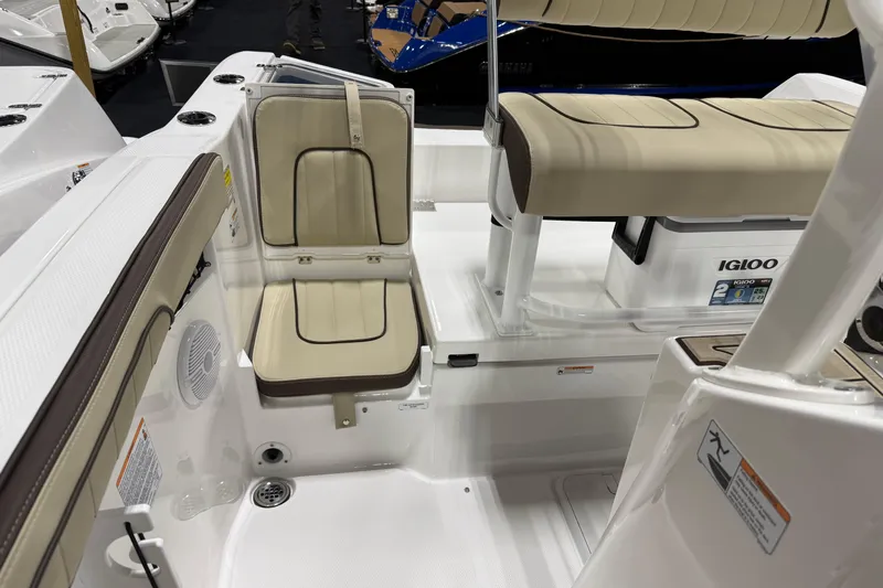 Slide: The Image of 2026 Yamaha Boats 222 FSH Sport interior with beige seating and Igloo cooler. - 6