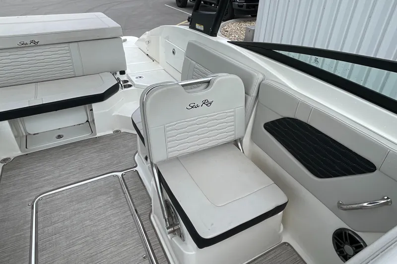 Slide: The Image of 2023 Sea Ray SPX 230 boat interior with white seating and modern design. - 10