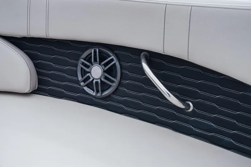 Slide: The Image of 2023 Sea Ray SPX 230 interior detail with speaker and handle on cushioned panel. - 14