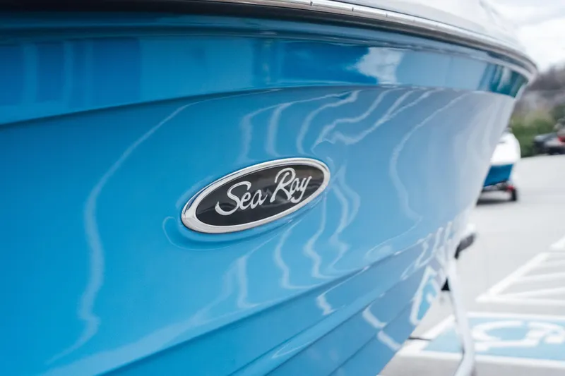Slide: The Image of 2023 Sea Ray SPX 230 boat with blue hull and logo detail. - 3