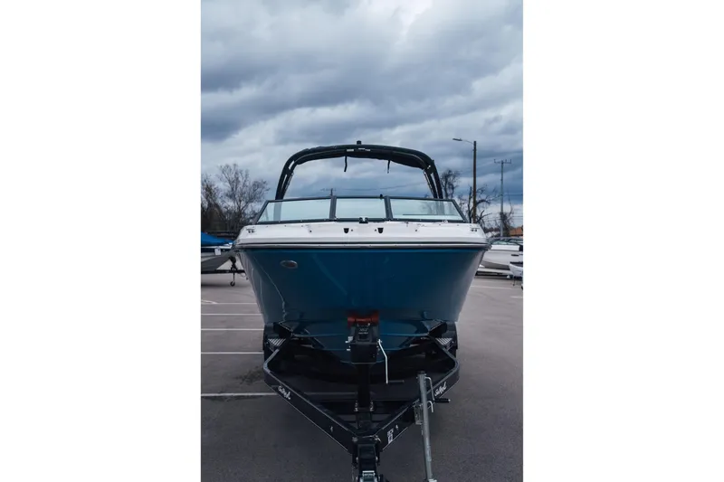 Slide: The Image of 2023 Sea Ray SPX 230 boat on trailer under cloudy sky. - 4