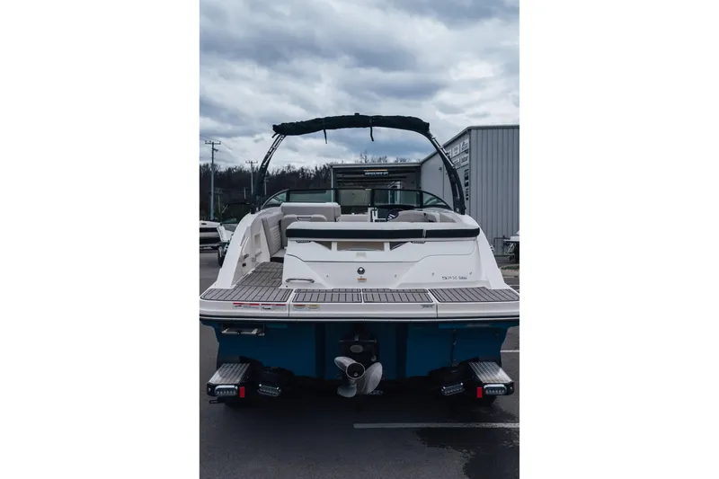 Slide: The Image of 2023 Sea Ray SPX 230 boat, rear view, docked under cloudy skies. - 5