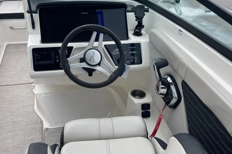 Slide: The Image of 2023 Sea Ray SPX 230 boat cockpit with steering wheel and control panel. - 8