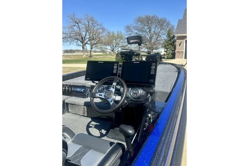 Slide: The Image of 2026 Phoenix 921 Elite X boat dashboard with steering wheel and dual monitors. - 5