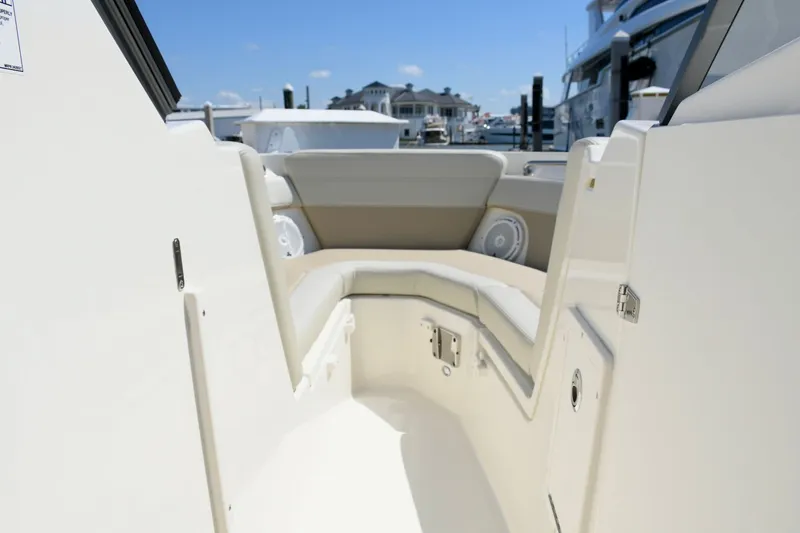 Slide: The Image of Interior of 2024 Boston Whaler 210 Vantage with beige seating area. - 13