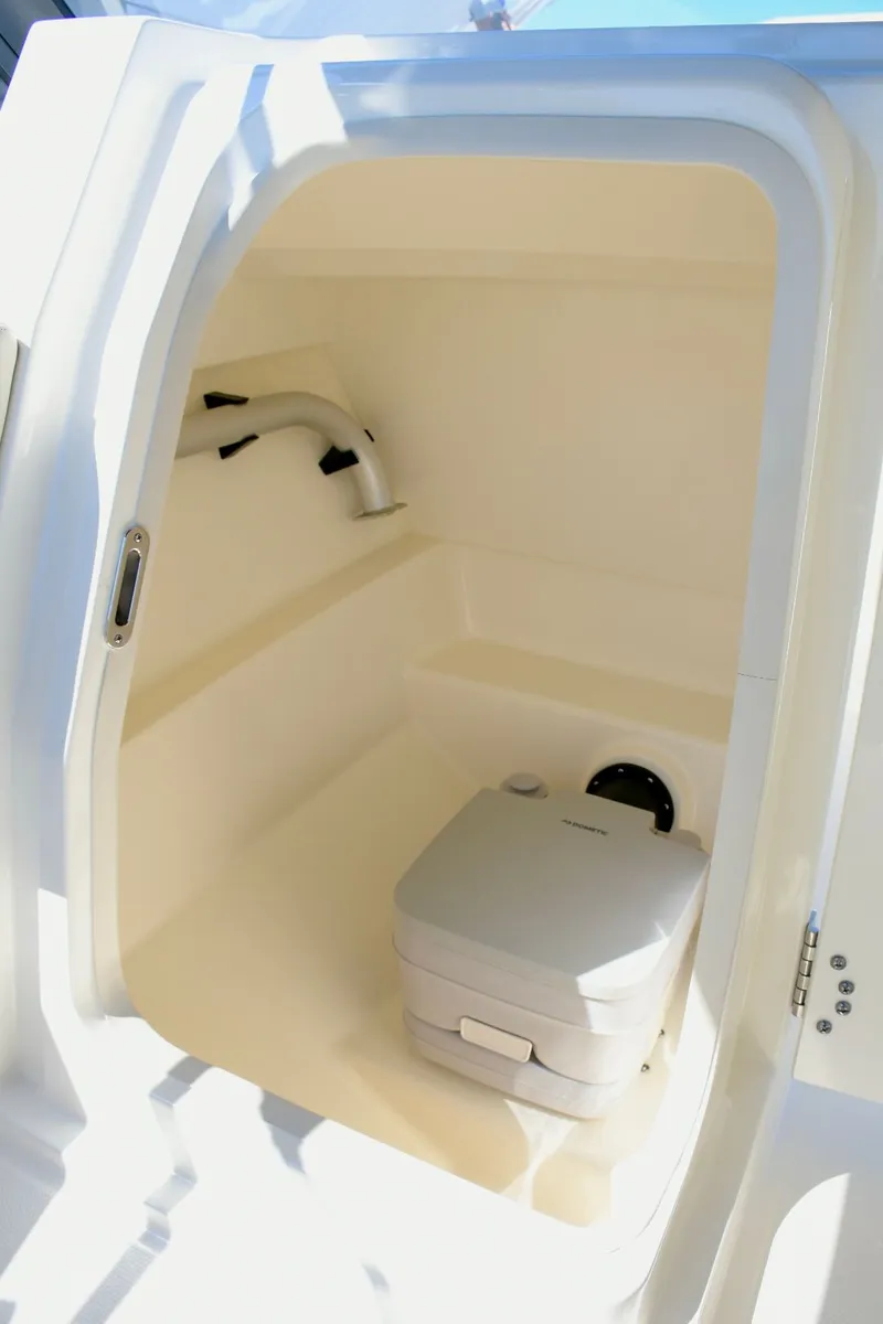 Slide: The Image of Interior of 2024 Boston Whaler 210 Vantage with portable toilet. - 17