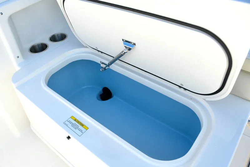 Slide: The Image of Boston Whaler 210 Vantage 2024, open storage compartment with blue interior lining. - 19