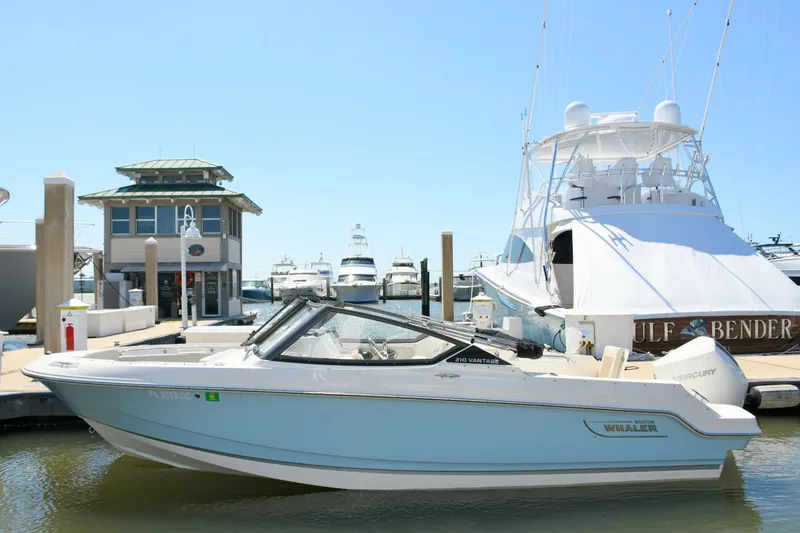 Slide: The Image of 2024 Boston Whaler 210 Vantage boat docked at marina. - 3