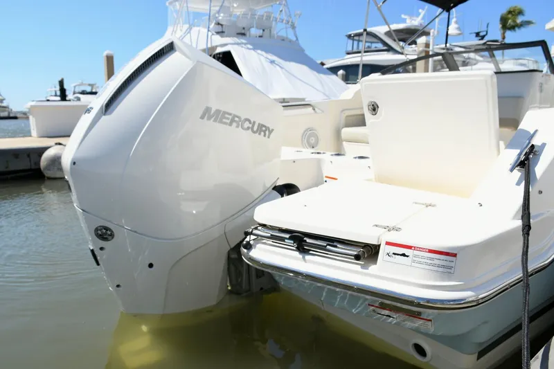 Slide: The Image of 2024 Boston Whaler 210 Vantage with Mercury engine at dock. - 5