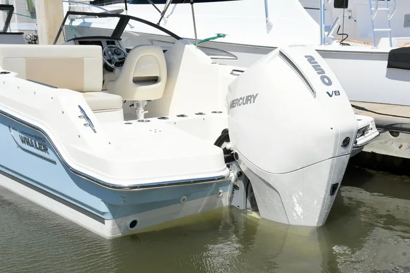 Slide: The Image of 2024 Boston Whaler 210 Vantage with Mercury V8 engine at dock. - 6