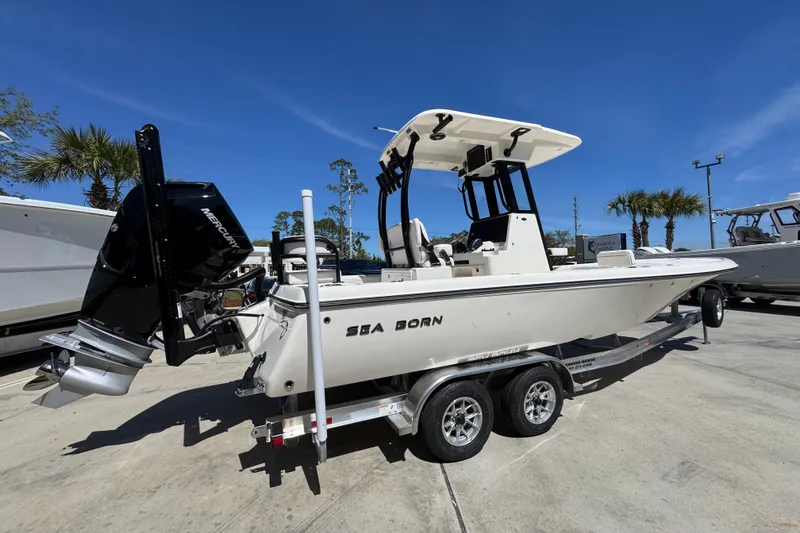 Slide: The Image of 2026 Sea Born FX25 Bay boat on trailer, featuring a powerful Mercury engine. - 10