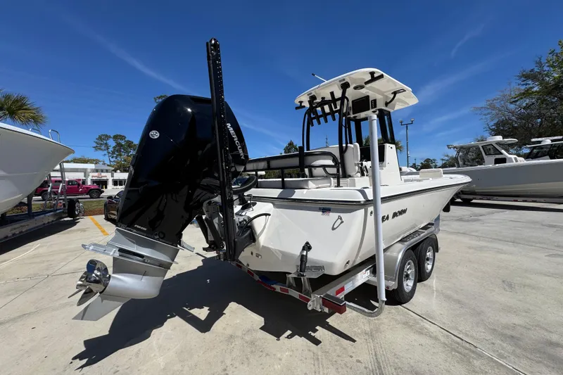 Slide: The Image of 2026 Sea Born FX25 Bay boat on trailer, featuring powerful outboard motor. - 11