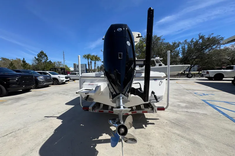 Slide: The Image of 2026 Sea Born FX25 Bay boat with outboard motor in a parking lot. - 12
