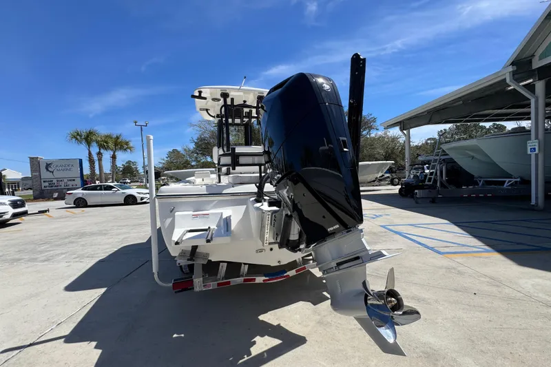 Slide: The Image of 2026 Sea Born FX25 Bay boat with powerful outboard motor in a sunny marina. - 13