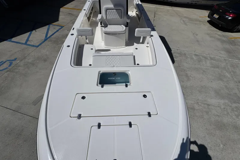 Slide: The Image of 2026 Sea Born FX25 Bay boat deck, featuring seating and storage compartments. - 20