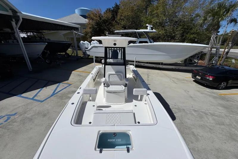 Slide: The Image of 2026 Sea Born FX25 Bay boat in a marina, showcasing sleek design and spacious deck. - 21
