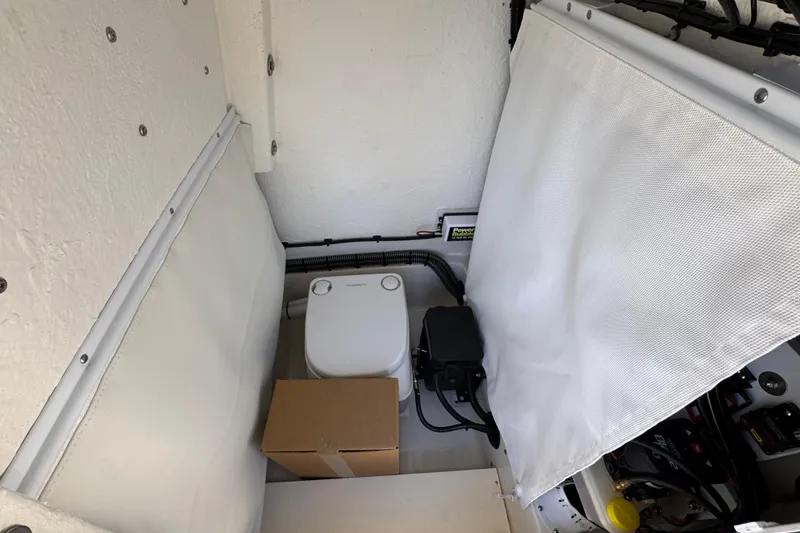 Slide: The Image of Interior of 2026 Sea Born FX25 Bay boat with compact toilet and storage. - 25