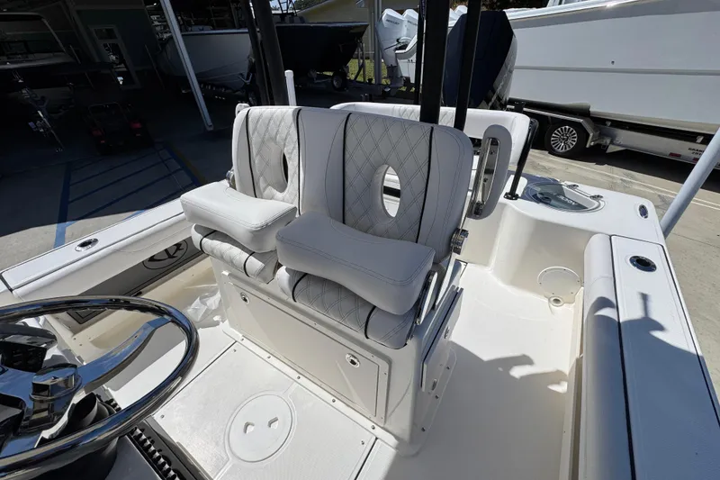 Slide: The Image of 2026 Sea Born FX25 Bay boat interior with plush seating and steering wheel. - 28