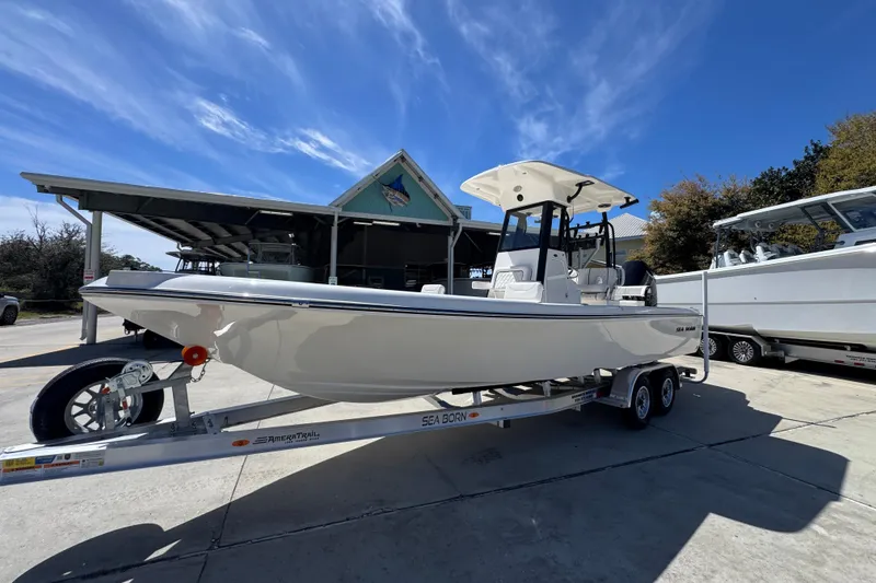 Slide: The Image of 2026 Sea Born FX25 Bay boat on trailer under clear blue sky. - 3