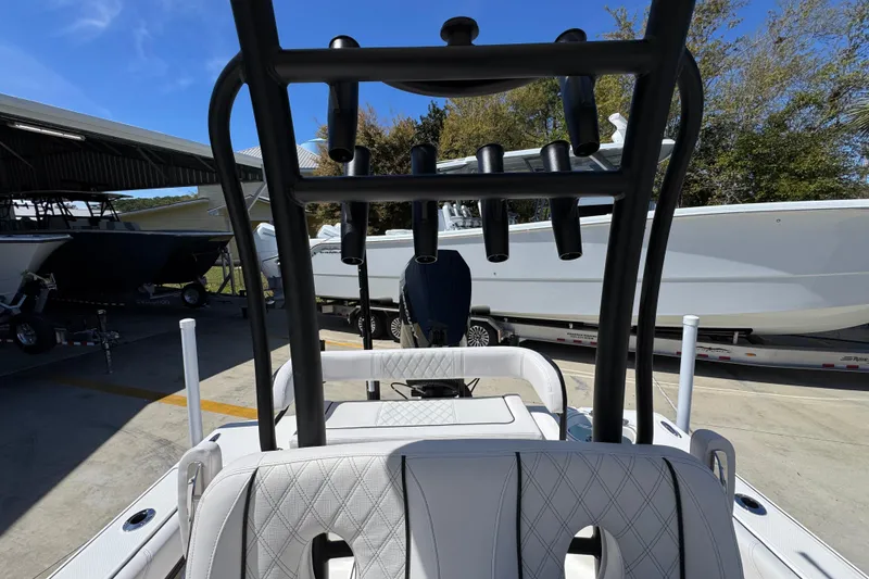 Slide: The Image of 2026 Sea Born FX25 Bay boat with rod holders, parked in a marina. - 30