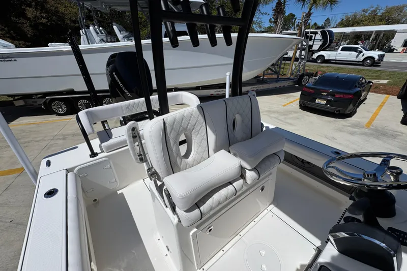 Slide: The Image of 2026 Sea Born FX25 Bay boat interior with plush seating and steering wheel. - 31