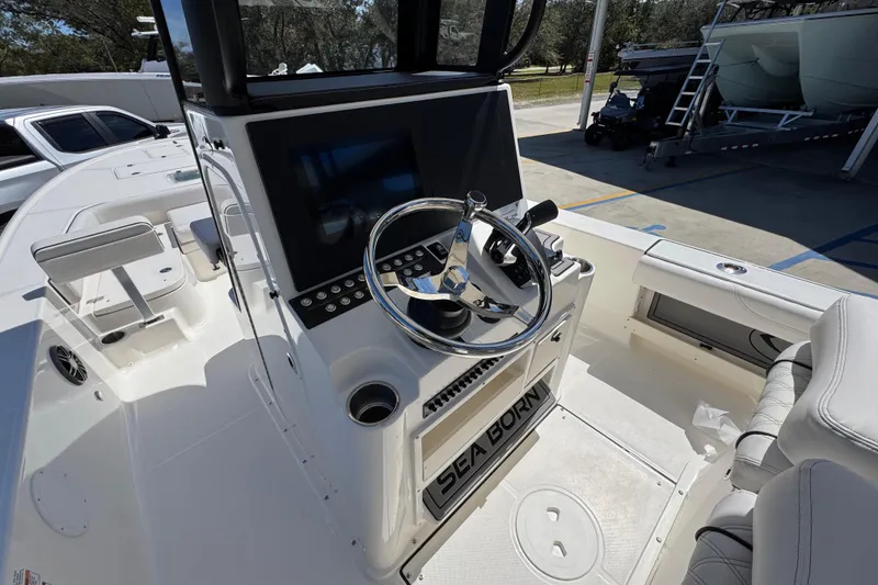 Slide: The Image of 2026 Sea Born FX25 Bay boat interior with steering wheel and control panel. - 32