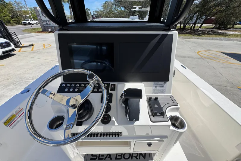 Slide: The Image of Steering console of 2026 Sea Born FX25 Bay boat with modern controls and display. - 33