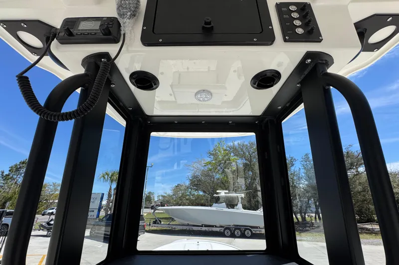 Slide: The Image of Interior view of 2026 Sea Born FX25 Bay boat console with controls and clear sky. - 37