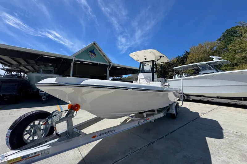 Slide: The Image of 2026 Sea Born FX25 Bay boat on trailer under clear blue sky. - 4