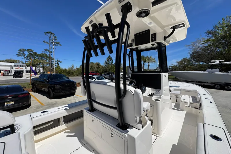 Slide: The Image of 2026 Sea Born FX25 Bay boat interior with modern console and seating, parked outdoors. - 40