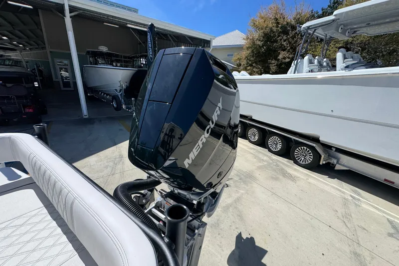 Slide: The Image of 2026 Sea Born FX25 Bay boat with Mercury outboard motor in a marina setting. - 44
