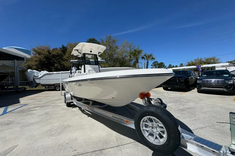 Slide: The Image of 2026 Sea Born FX25 Bay boat on trailer in sunny outdoor setting. - 6
