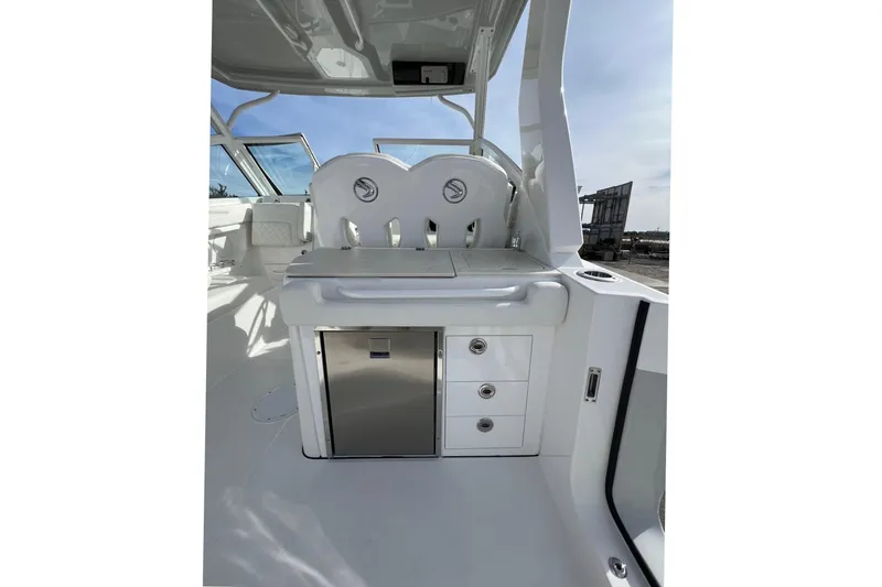 Slide: The Image of 2023 Edgewater 262CX Crossover boat interior with seating and storage compartments. - 12