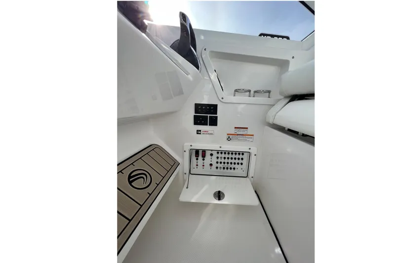 Slide: The Image of Interior view of 2023 Edgewater 262CX Crossover boat, featuring control panel and seating area. - 19