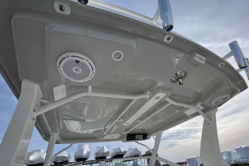 Slide: The Image of 2023 Edgewater 262CX Crossover boat roof with speakers and rod holders. - 2