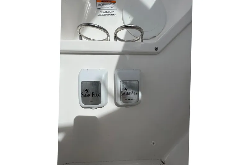 Slide: The Image of SmartPlug outlets on 2023 Edgewater 262CX Crossover boat, featuring dual connectors. - 20