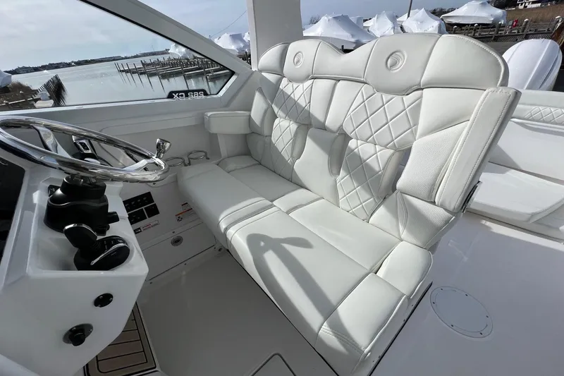 Slide: The Image of Luxurious interior of 2023 Edgewater 262CX Crossover boat with plush white seating. - 5