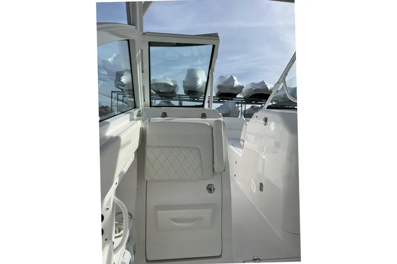 Slide: The Image of 2023 Edgewater 262CX Crossover boat interior with sleek white design and modern features. - 6