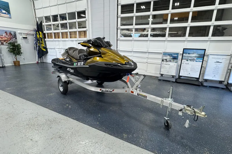 The Image of 2023 Kawasaki Ultra LX jet ski on trailer in showroom. - 0