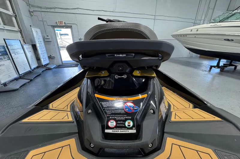 Slide: The Image of 2023 Kawasaki Ultra LX jet ski in showroom, featuring safety warnings and sleek design. - 10
