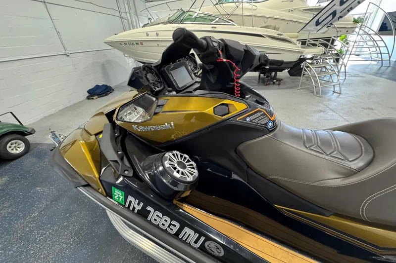 Slide: The Image of 2023 Kawasaki Ultra LX jet ski in showroom, featuring sleek design and advanced controls. - 11