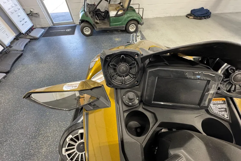 Slide: The Image of 2023 Kawasaki Ultra LX dashboard with speakers and display in a garage setting. - 13