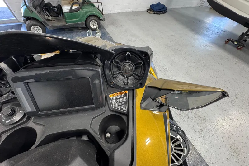 Slide: The Image of 2023 Kawasaki Ultra LX dashboard with display, speaker, and mirror in a showroom. - 14