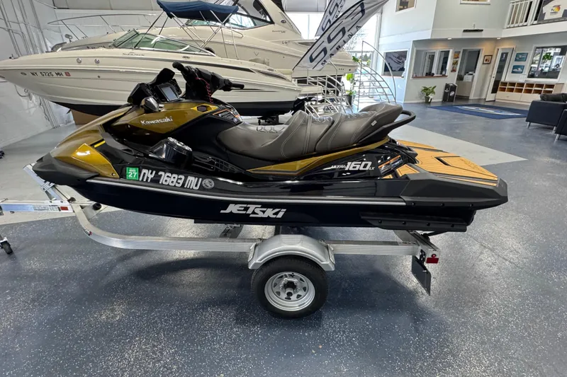Slide: The Image of 2023 Kawasaki Ultra LX Jet Ski on trailer in showroom. - 2