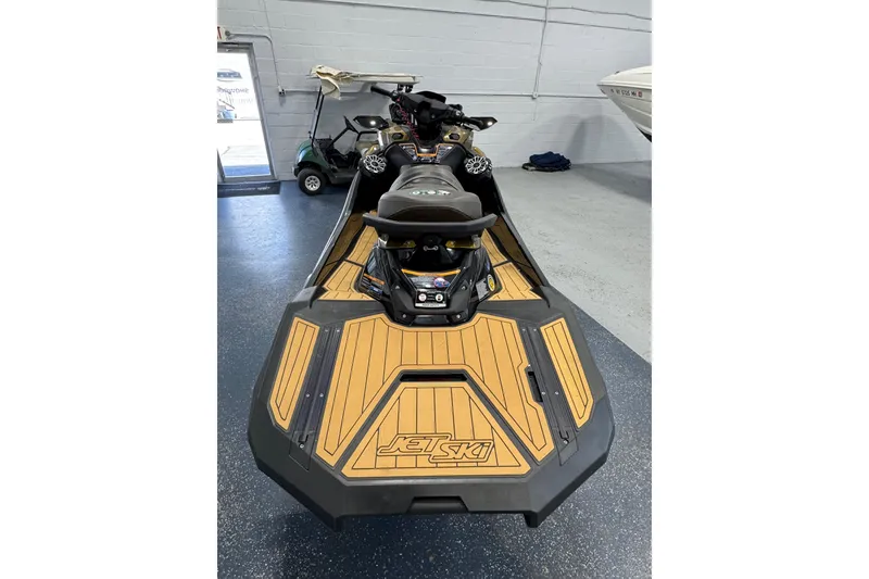 Slide: The Image of 2023 Kawasaki Ultra LX Jet Ski in showroom, featuring sleek design and wood-style deck. - 3