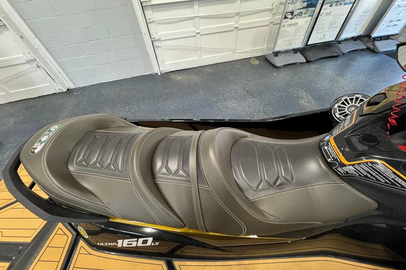 Slide: The Image of 2023 Kawasaki Ultra LX jet ski seat in a showroom setting. - 7