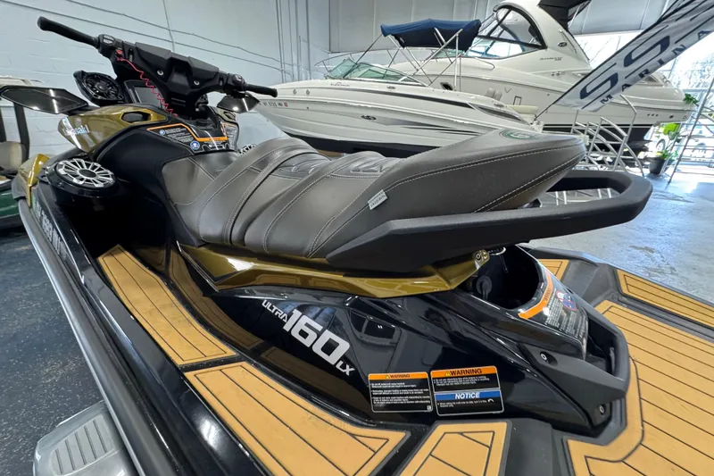 Slide: The Image of 2023 Kawasaki Ultra LX jet ski in showroom, featuring sleek design and comfortable seating. - 8