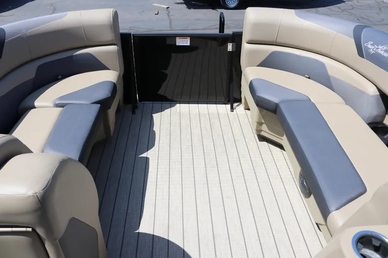 Slide: The Image of 2025 SunChaser Geneva Sport 23 LR PSB boat interior with beige and gray seating. - 11
