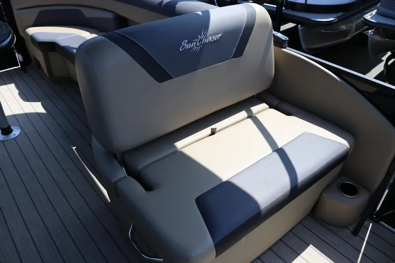 Slide: The Image of SunChaser Geneva Sport 23 LR PSB 2025 boat seating with logo, featuring beige and black upholstery. - 14