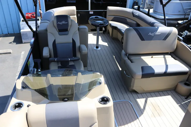 Slide: The Image of 2025 SunChaser Geneva Sport 23 LR PSB pontoon boat interior with luxurious seating and helm. - 16